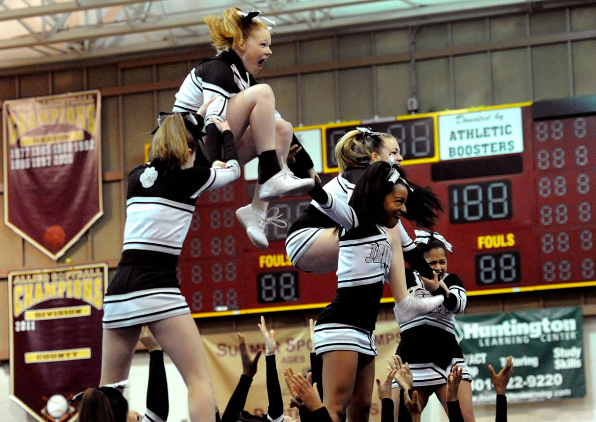 Cheerleader Alyssa Unowitz, top left, gets ready to do the splits while performing a stunt with her Northwest High School team from Germantown, Md.