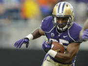 Washington's Bishop Sankey runs the ball against Boise State in the first half of a NCAA college football game, Saturday, Aug. 31, 2013, in Seattle. (AP Photo/Ted S.