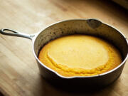 Pour mixture into the hot skillet and bake until top begins to crack and edges are golden brown, 20 to 22 minutes.