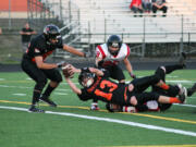 Brandon Casteel (13) gets the football across the goal line for a Washougal touchdown Friday, at Fishback Stadium.