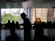 A waitress serves customers in New York.