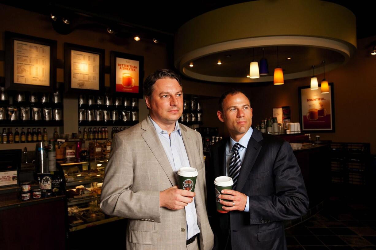 Tully's Chief Operating Officer Tod McDonald, left, and Chairman Michael Avenatti drink coffee at the store slated for remodel near Pike Place Market in Seattle.