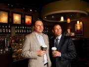 Tully's Chief Operating Officer Tod McDonald, left, and Chairman Michael Avenatti drink coffee at the store slated for remodel near Pike Place Market in Seattle.