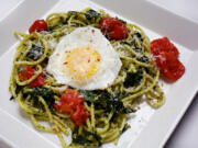 With a sunny-side egg on top, Spaghetti with Greens and Pistachio Pesto is a rich and hearty dish.