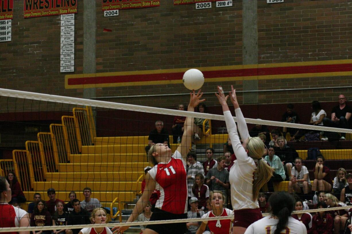 Camas middle blocker Carly Banks gets her fingertips on the volleyball.