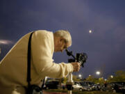 Stan Seeberg hosts an informal moon-viewing party Monday at the Walmart on Northeast 104th Avenue, where he works as a greeter.