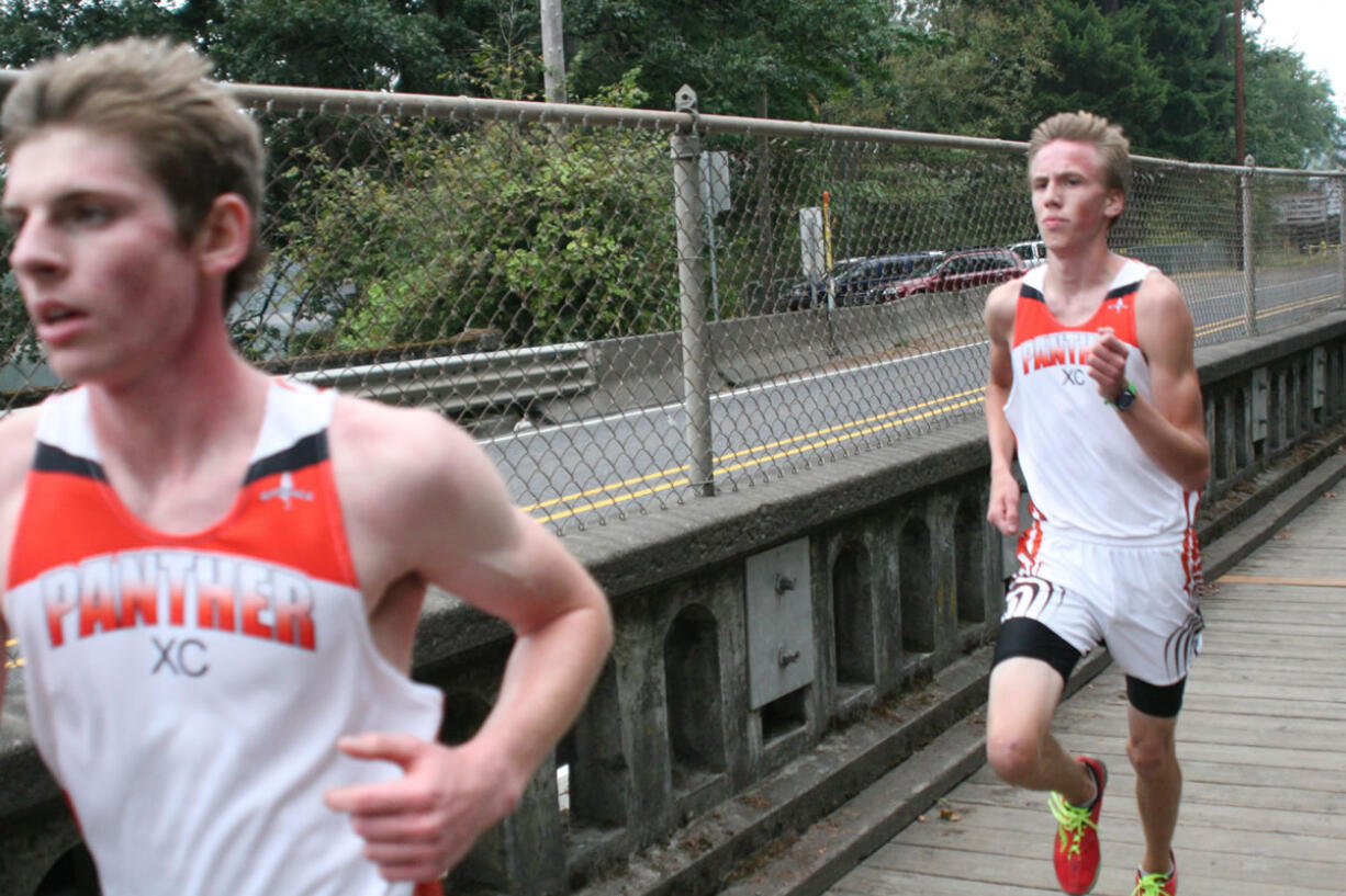 Washougal seniors Sean Eustis (left) and Isaac Stinchfield sprint to the finish line Thursday, at Round Lake in Camas.