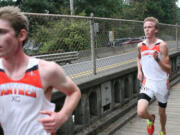 Washougal seniors Sean Eustis (left) and Isaac Stinchfield sprint to the finish line Thursday, at Round Lake in Camas.