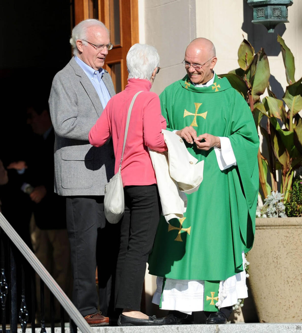 Pastor Ronald J. Rozniak greets parishioners at Our Lady of Mt. Carmel Catholic Church in Ridgewood, N.J., on Sunday.