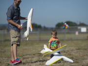 Reid Isaacson and his son Ronan play with foam gliders during Pearson Field Education Center's Open Cockpit Day on Aug.