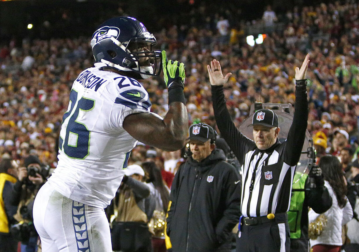 Seattle fullback Michael Robinson gestures to silence the crowd after scoring a touchdown at Washington during the Seahawks' playoff win last season.