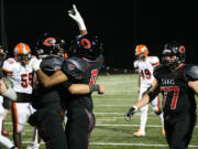 Reilly Hennessey and James Price celebrate after Hennessey scored a touchdown for Camas Friday, at Doc Harris Stadium.