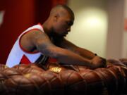 Portland Trail Blazers' Damian Lillard signs basketballs during the team's NBA basketball media day in Portland, on Monday.