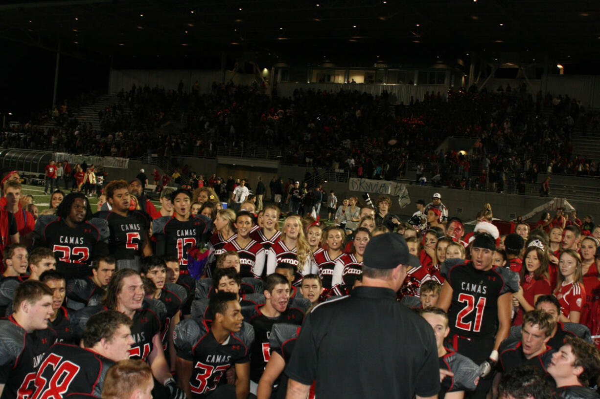 In a post-game huddle, the Camas Papermakers celebrate their 42-17 win against Skyview Friday night. It was the Papermakers' first league game following its move to the GSHL's Class 4A -- the largest classification in the state. Read the Tuesday, Oct.