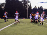 Washougal defensive lineman Caleb Economides blind sides R.A. Long quarterback Ryan Peerboom in the end zone to give the Panthers two points on a safety.