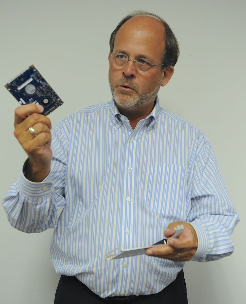 Randy Barber, president of CRU Inc., explains a device designed to safely store digital photo files.