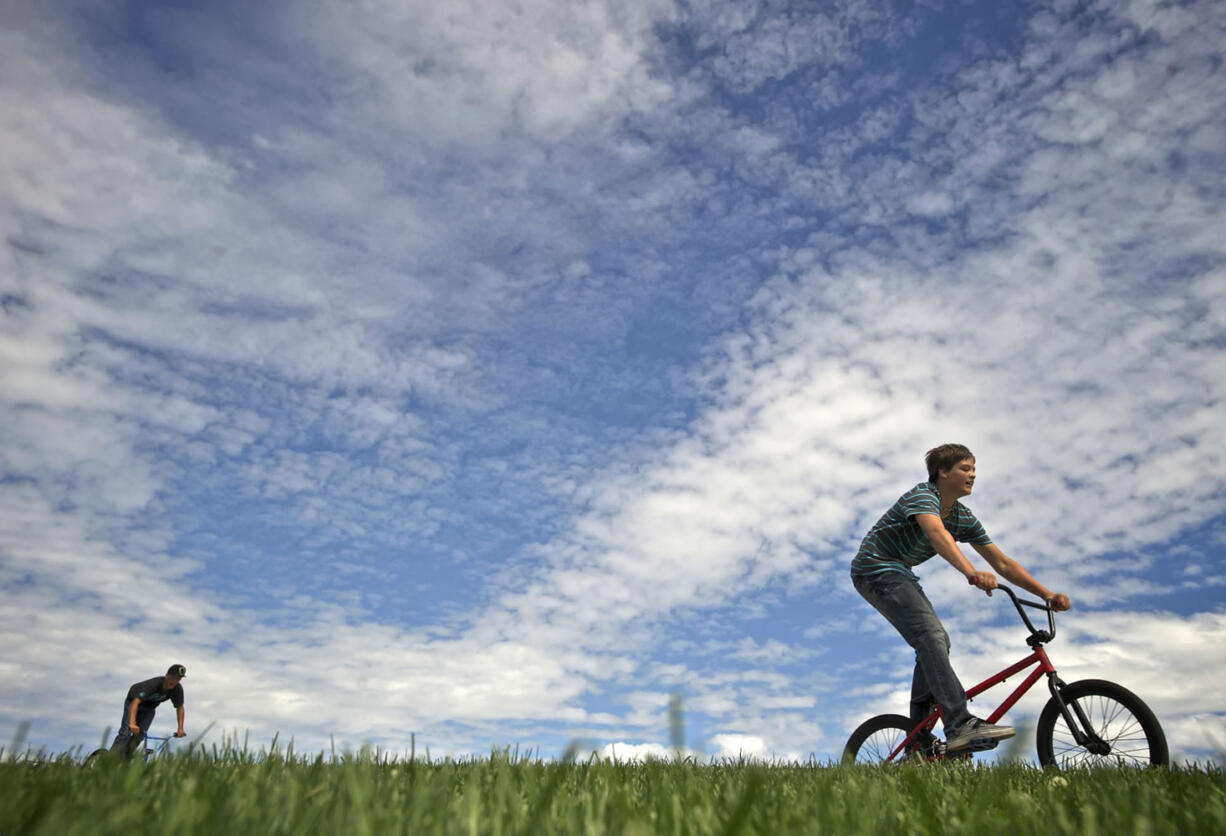 Hunter Ingraham, 14, right, and Noah Koonce, 14, ride their bikes at the Rolling Freedom Skate Park at Horseshoe Park in Woodland in late August.