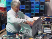 Faye Schanilec, a volunteer, sorts donations at the Inter-Faith Treasure House food bank. The Treasure House provides 45,000 to 65,000 pounds of food a month for area families. That includes monthly food boxes, USDA commodities, a backpack home program for children on weekends and meals served at the Lost &amp; Found Cafe. Public and private donations have decreased, and the Treasure House no longer receives goods from the Oregon Food Bank. iWe need food,i said Treasure House Executive Director Nancy Wilson.