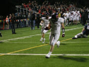 The Camas football players, coaches and fans go crazy as Brad Hansen returns a fumble for a touchdown Friday, at Kiggins Bowl.