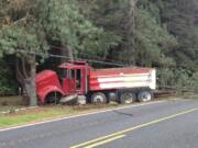 This dump truck veered off the roadway on Northeast 199th Street, went through a barbed wire fence and struck a tree, which took out power lines.