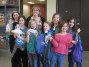 Meadow Homes: Members of Vancouver Girl Scout Troop 42561 donate $506 on April 10 to the Share Backpack Program, which helps provide food to children in need. From left back: Maddy Surface, Becky Parker of Share, Lily Jonas, Kenna Yakimchick.