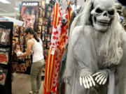 Jessika Jaramillo, of Hollywood, Fla., shops for costume ideas at Spirit Halloween store.