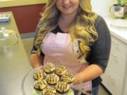 Bethani Higdon shows examples of chocolate cupcakes at the future site of WildFlour Cafe &amp; Cupcakes. &quot;It's all from scratch,&quot; she said. &quot;Nothing is from a box.&quot; Bethani and her mother, Connie, plan to open the cafe in Washougal Town Square this Friday. &quot;She loves to bake and cook,&quot; Connie said.