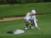 Brian Humphreys places his golf ball on the 18th green Oct. 8, at Tri-Mountain.