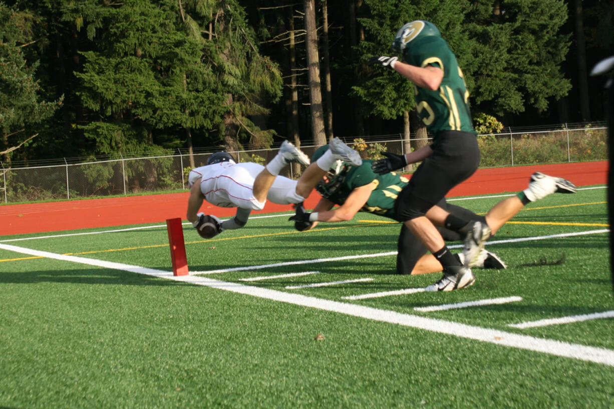 Zach Eagle dives across the goal line to score a 38-yard touchdown interception for Camas Friday, at McKenzie Stadium.