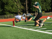 Zach Eagle dives across the goal line to score a 38-yard touchdown interception for Camas Friday, at McKenzie Stadium.