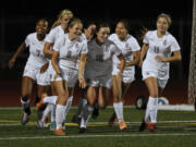 Union midfielder Melissa Foster (8) celebrates with her Titans teammates after scoring against Camas.