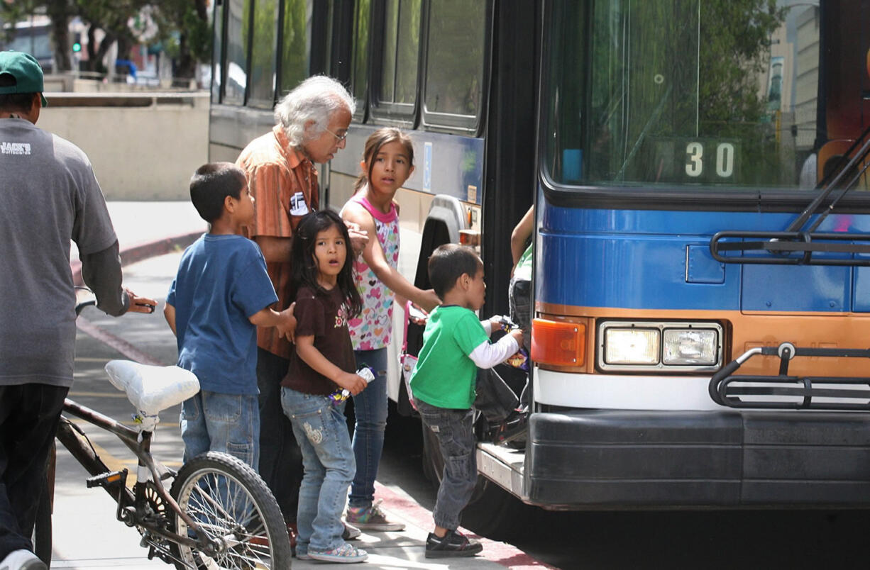 Riders board a FAX bus in Fresno, Calif.