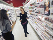 At the Target store in downtown Minneapolis, beauty concierge Chelsea Mathison helps a customer find tea tree oil.