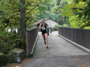 Alexa Efraimson crosses at the creek at Lewisville Park Thursday.