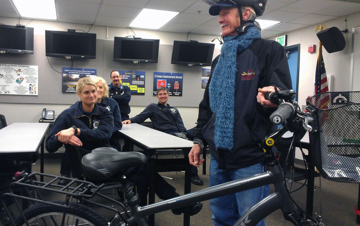 Woody Woodworth, 64, of Hazel Dell is surprised Sunday night with the gift of a new bike and bike gear, given to him by Clark County sheriff&#039;s deputies. They presented him with the gifts at the Fire District 6 station on Hazel Dell Avenue.