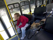 Harry Kiick of Vancouver rides a C-Van bus with his service dog, Sasha, in 2009.