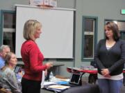 Dawn Tarzian (left), Washougal School District superintendent, administers the oath of office to Jocelyn Lindsay, while board members Elaine Pfeifer and Blaine Peterson look on.