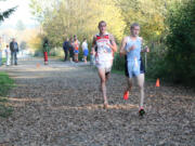 Washougal's Thomas Normandeau and Aaron Brumbaugh of Mark Morris battle for the lead in the 2A league championship boys cross country race Thursday, at Hockinson Meadows.