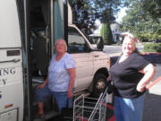 Columbia House residents Lorraine Harrington, center, and Darlene Pieper get on the Plan 770 van for a recent Farmers Market run.