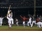 Sox relief pitcher Koji Uehara and catcher David Ross celebrate after getting the final out of the World Series.