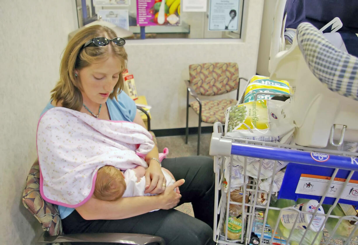 Stephanie Bryson nurses her daughter, Catherine, in the pharmacy area of a Kroger grocery store in Flowood, Miss. in 2006.