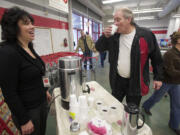 Hazel Dell Salvation Army thrift store manager Laurie Hill serves customer John Scherger a free cup of coffee made with beans from Vietnam.