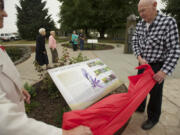 Ginny Frosh and Ted Durgan unveil one of three new interpretive panels honoring the Chinookan people Thursday at the Parkersville National Historic Site.