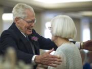 John Deurwaarder and his bride, Alta Lunsford, share a hug after Saturday's wedding.