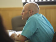 Michael Boswell listens to his former girlfriend answer questions from a prosecuting attorney Monday October 29, 2012 at the Clark County Courthouse in Vancouver, Washington.