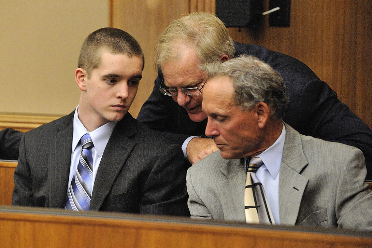 Anthony Bittner, left, consults with his attorney's, Thomas Phelan, center, and Steven Myers, right, before pleading guilty to charges of burglary and possession of stolen property in July 2011.