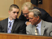 Anthony Bittner, left, consults with his attorney's, Thomas Phelan, center, and Steven Myers, right, before pleading guilty to charges of burglary and possession of stolen property in July 2011.