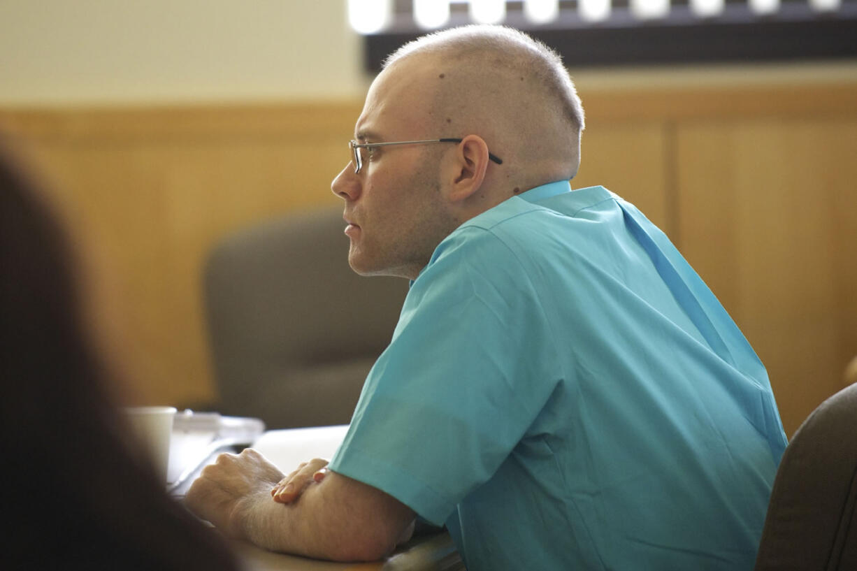 Michael Boswell listens to his former girlfriend answer questions from a prosecuting attorney Monday October 29, 2012 at the Clark County Courthouse in Vancouver, Washington. Boswell is on trial for attempted murder of his He is accused of trying to poison and shoot her in Yacolt last year.