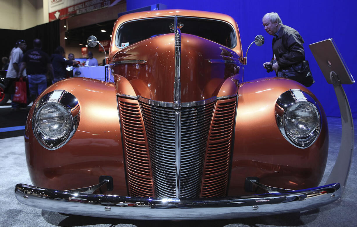 A man looks inside the 1940 &quot;Catch Me If You Can!&quot; Ford Coupe 2012 Amsoil/Street Rodder Project car.