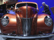 A man looks inside the 1940 &quot;Catch Me If You Can!&quot; Ford Coupe 2012 Amsoil/Street Rodder Project car.